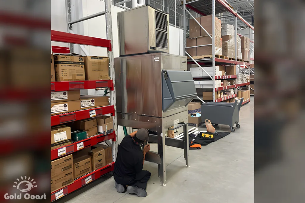 Gold Coast Refrigeration technician cleaning a commercial ice machine